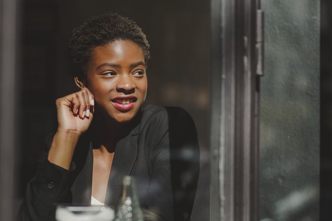 Smiling stylish Black woman in cafe
