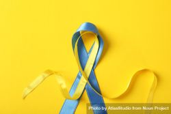 Ribbon in Ukrainian flag colors on yellow background 5pJOjb