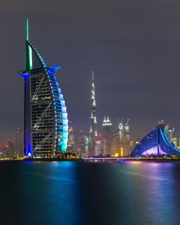 Madinat Jumeirah across the sea at night in Dubai, UAE