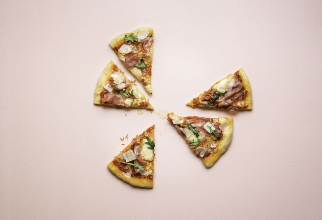 Pizza prosciutto slices on pink background