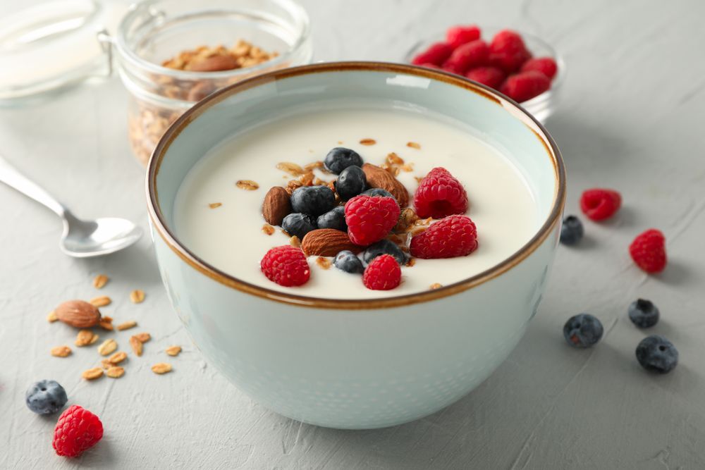 Flat lay composition with parfaits dessert and ingredients on cement background