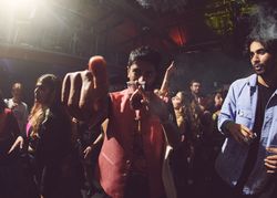 London, England, United Kingdom - Nov 9, 2022: Man holding drink and pointing at camera