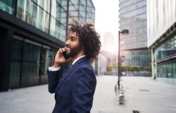 Curly man smiling at street