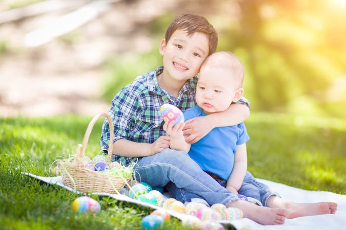 Boys Outside in Park Playing with Easter Eggs