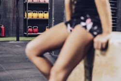Slender woman having break in fitness club