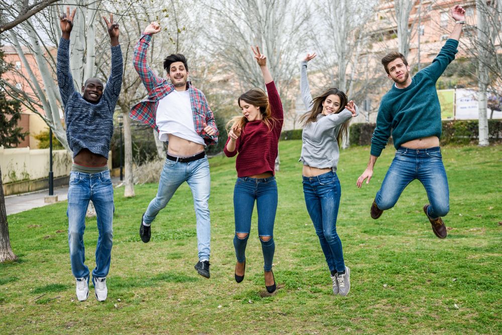 Friends jumping together in park