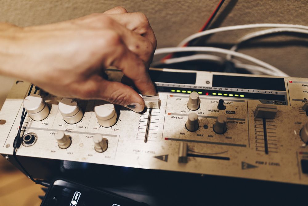 Anonymous male musician tuning an amplifier