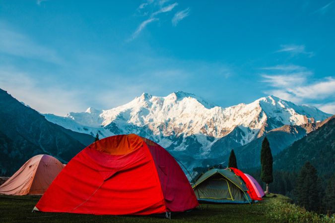 Camping facing snow capped mountains in Pakistan