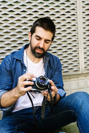 Man in denim checking camera