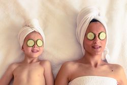Mother and son with cucumber mask
