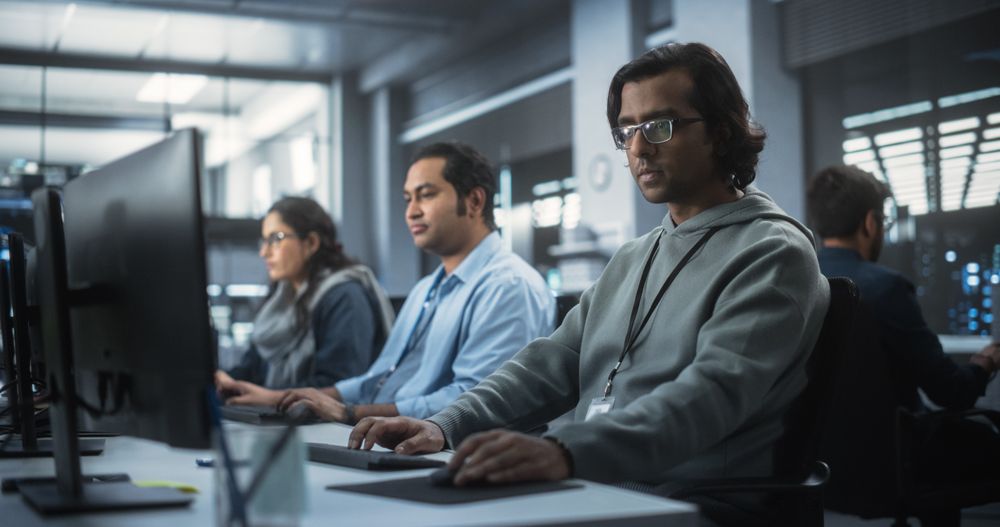Group of Multicultural South Asian Men and Women Working in a Research Center