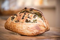 Delicious freshly baked rustic bread with olives