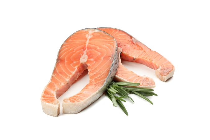 Fresh raw salmon meat and rosemary isolated on blank background