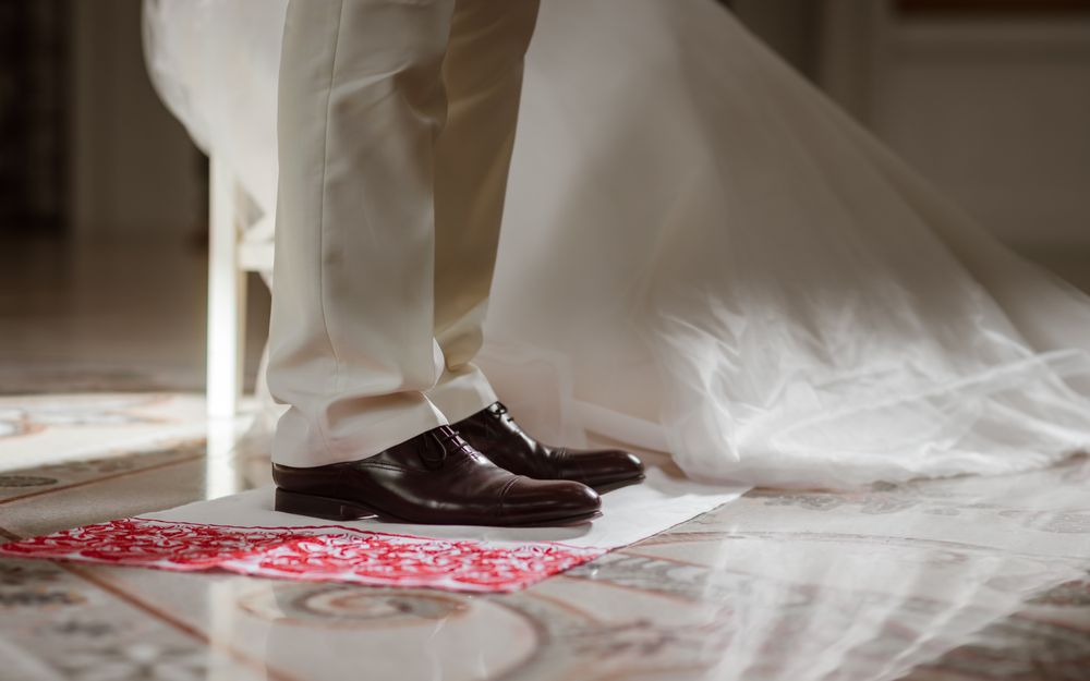 Delicate details of the wedding celebration. Newlyweds hold hands.