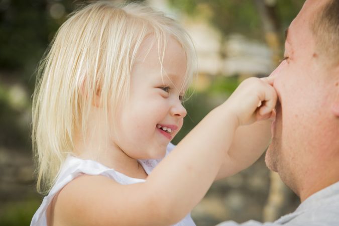 Father Playing With Cute Baby Girl Outside at the Park