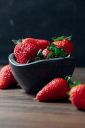 Fresh ripe strawberries in concrete bowl