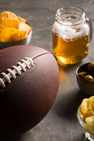 Snacks, beer and american football ball