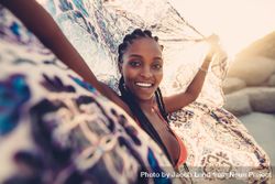 African young female on beach with a scarf looking at camera and smiling 4AmEz4