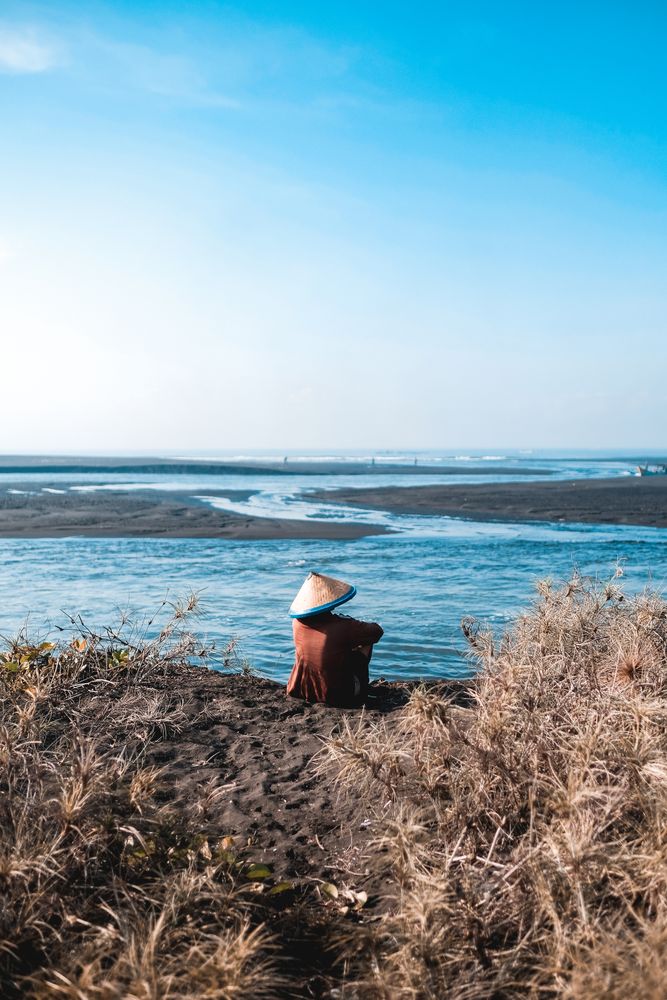 Man sitting on river bank