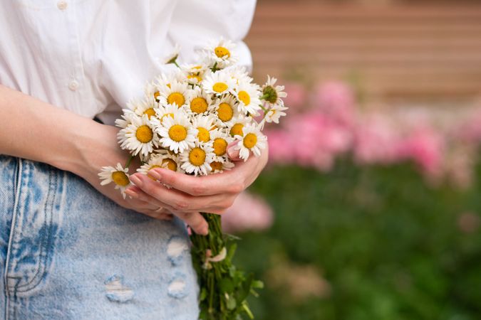 Woman with a bouquet of chrysanthemums. Background flowers