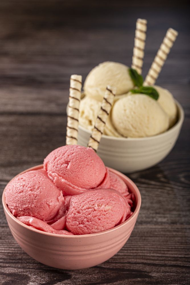 Bowls with strawberry and vanilla ice cream.