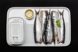 Raw fish without heads on plate