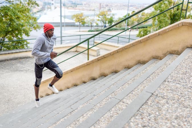 Athletic male working out by sprinting upstairs