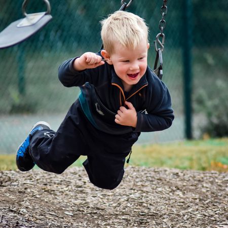 Boy riding a swing