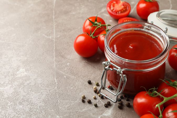 Composition with tomatoes on gray background. Ripe vegetable