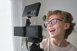 Teen smiling at camera while shooting vlog