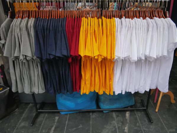 Clothing rack of assorted colorful t-shirts