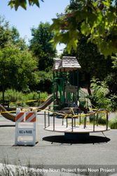 Merry-go-round and play equipment at public park closed during pandemic bDjxr5
