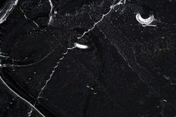 Fragment of thin ice on dark frozen river