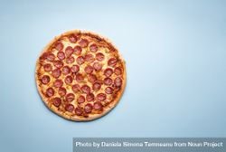 Whole pizza on a blue background 0Vvpv0