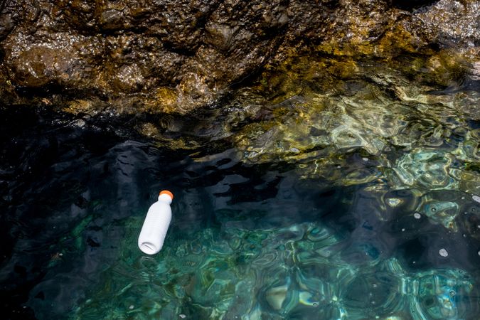 Plastic bottle floating on water