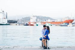 Loving couple embracing on urban pier with dock