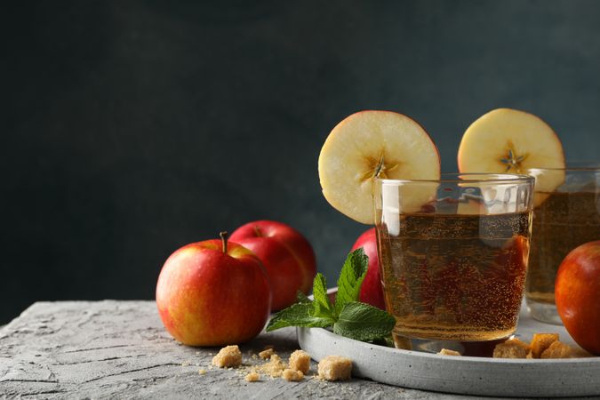 Composition with cider, sugar and apples on gray table