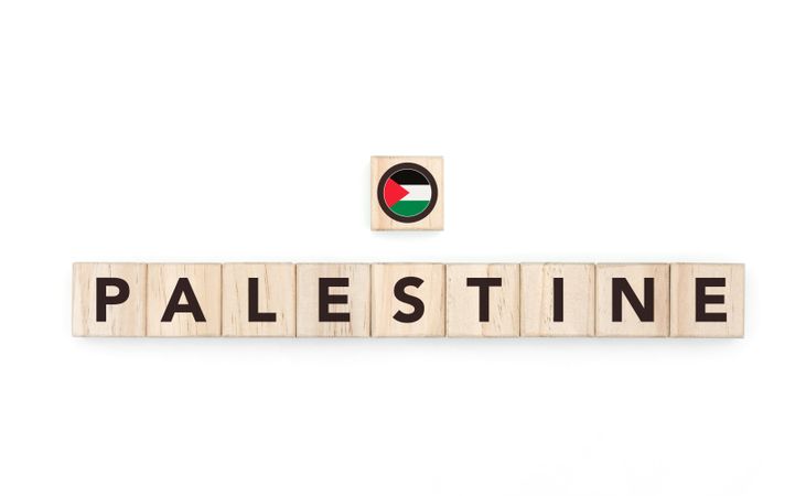 Wooden blocks bearing the name and flag of Palestine. Palestinian and Arab Culture, national identity, travel, and geography in a copy space design.