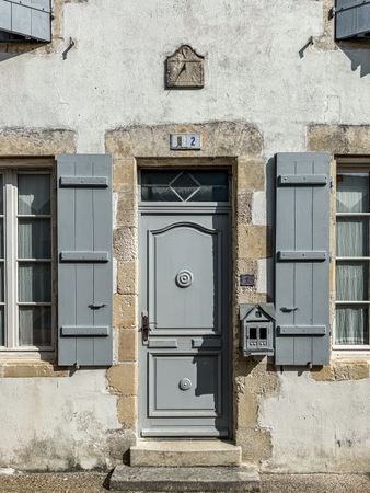 Grey door and sun dial, ile de Ré, France