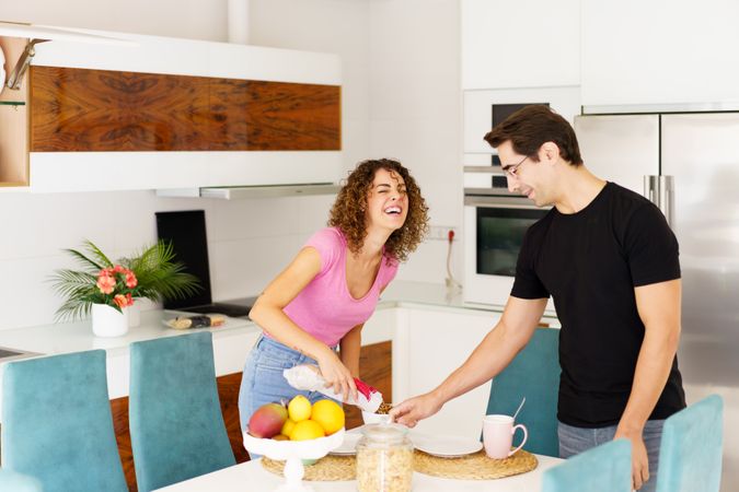 Happy couple cooking together in bright kitchen