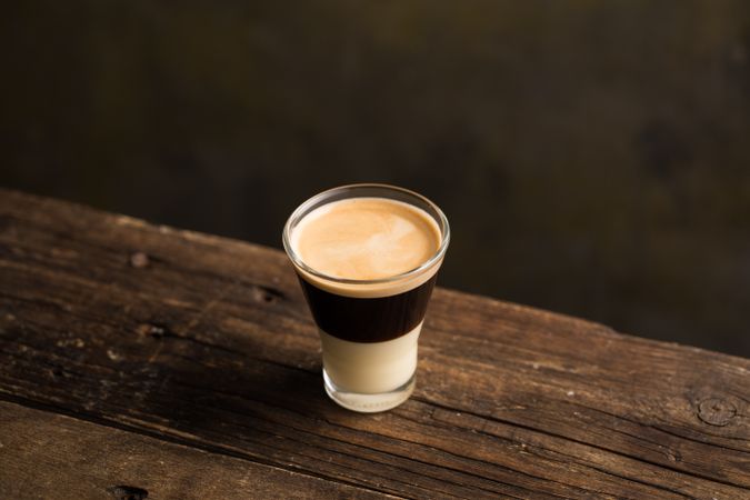 Cups of tasty hot coffee drink on wooden table