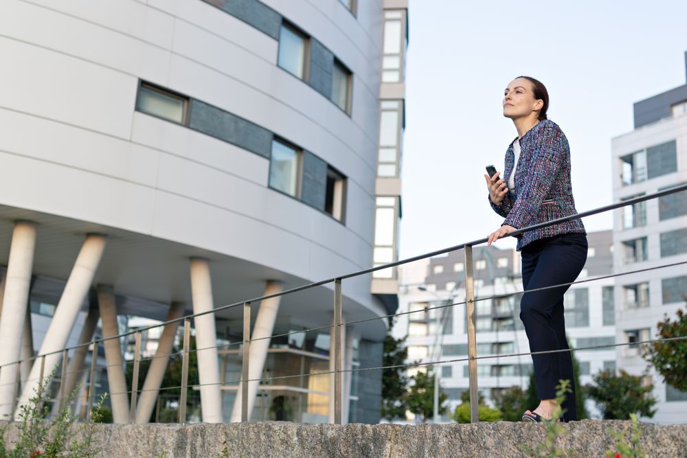 Smiling businesswoman using the cellphone