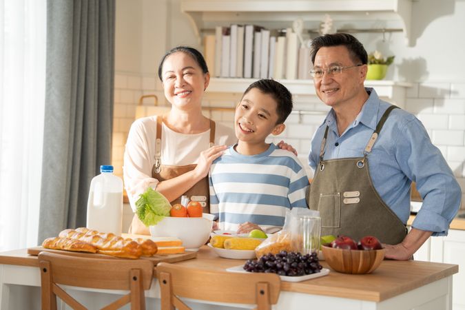 Portrait of Asian family preparing food in the kitchen