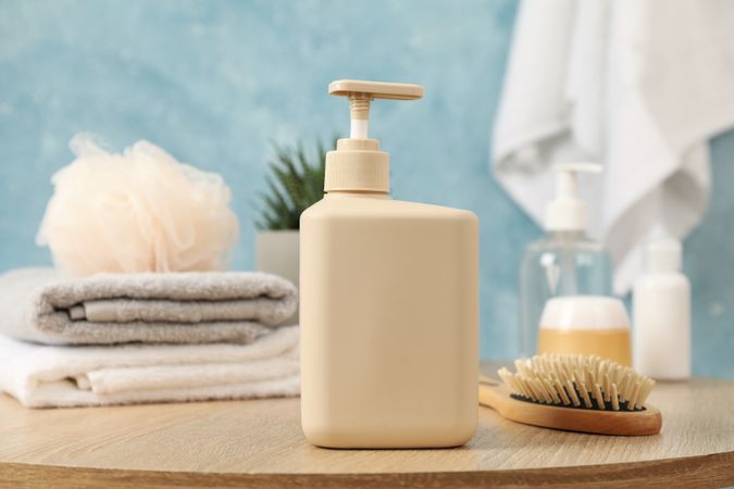 Bottle for liquid soap on wooden table. Personal hygiene concept