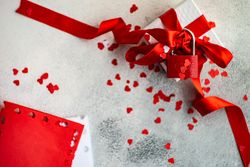 Top view of gift box with red ribbon & red padlock