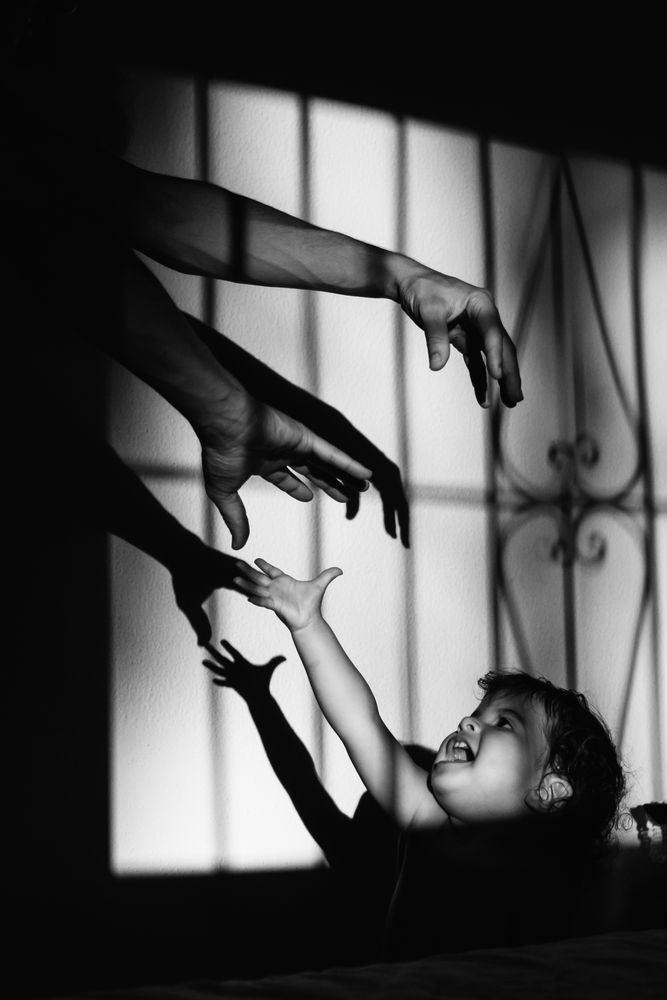 anonymous father playing with hands with kid