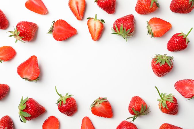 Flat lay composition with strawberries on light background, space for text. Summer sweet fruits and berries