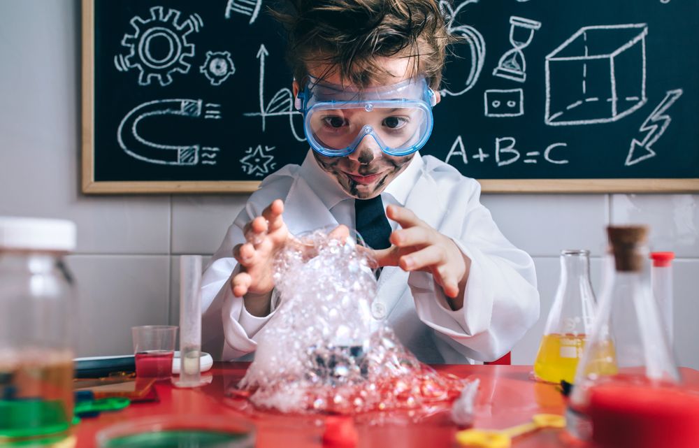 Happy kid making experiments with soap foam