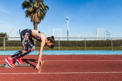 fit woman running on track