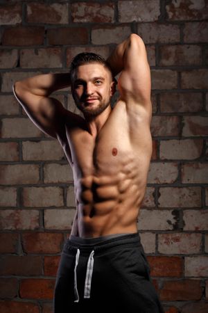 Bodybuilder practicing poses ahead of physique competition